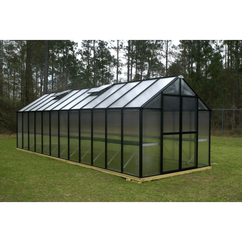 garden setting of the 24ft black monticello greenhouse premium package