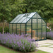 Grandio Ascent 8×8 Greenhouse placed in a garden on a concrete floor