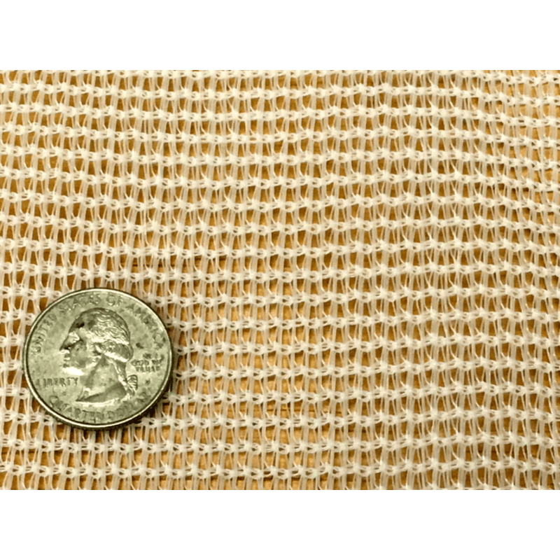 close up image of RSI white tropical weather shade cloth with grommets with a quarter on top of it for scale.
