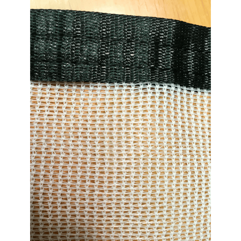close up image of the edge of of RSI white tropical weather shade cloth with grommets.