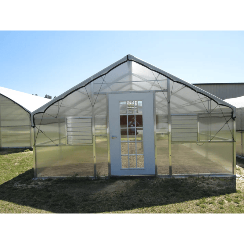 image of riverstone industries whitney educational greenhouse kit with 8ft high walls on a grassy area