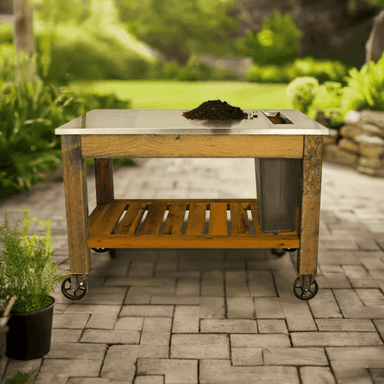 front view of the lee display gardener's pro potting table and it is placed in a garden
