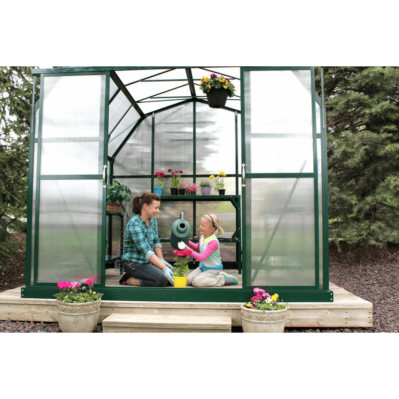 woman and a kid working in the grandio elite 8×12 greenhouse