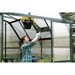 woman adjusting roof vents of grandio elite 8x24 greenhouse
