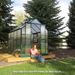 woman sitting outside the grandio greenhouse element 6×8