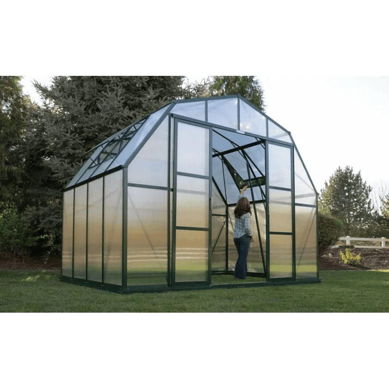 woman standing inside grandio summit 12×16 greenhouse