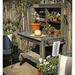 side view of the lee display redwood potting table with plants