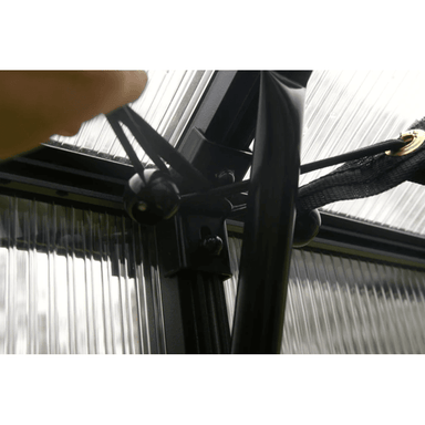 person fastening the rsi bungee balls for securing the shade cloth