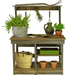 plants and tools on the lee display rustic gardening workbench