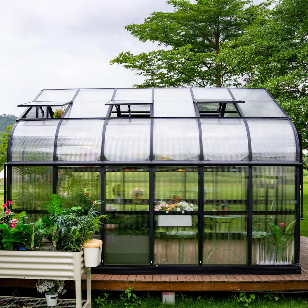 Side view of the Vego Garden Pacific 12.5ft greenhouse showing polycarbonate walls, aluminum frame and open roof vents.