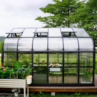 Side view of the Vego Garden Pacific 12.5ft greenhouse showing polycarbonate walls, aluminum frame and open roof vents.