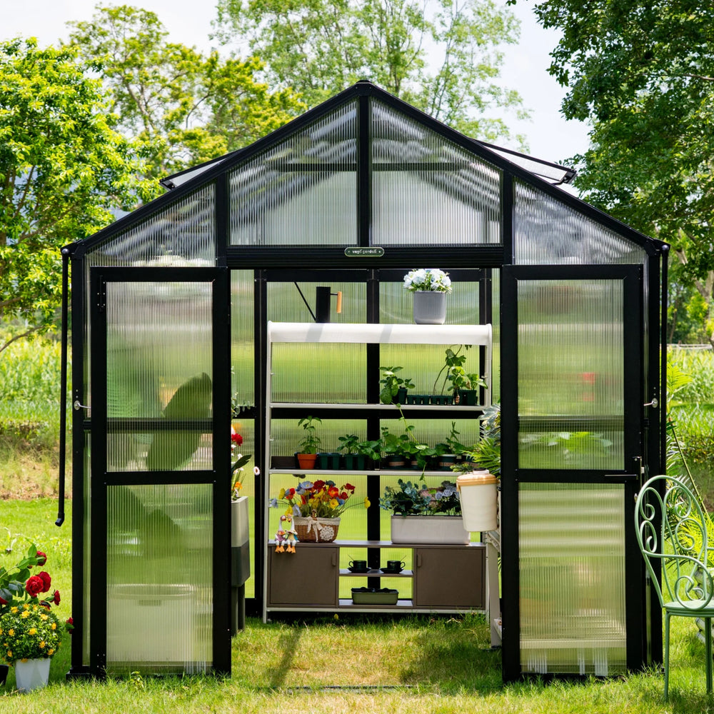 Front view of the Vego Garden Victorian Greenhouse 8.5ft Wide with polycarbonate glazing, double doors and plant shelving inside.