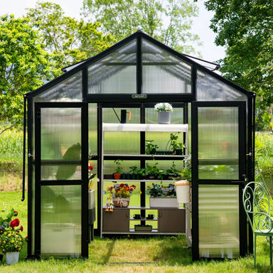 Front view of the Vego Garden Victorian Greenhouse 8.5ft Wide with polycarbonate glazing, double doors and plant shelving inside.