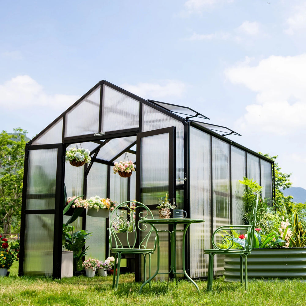 Vego Garden Victorian Greenhouse 8.5ft Wide with polycarbonate walls, pitched roof vents, open double doors and patio furniture.