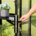 Close-up of the black greenhouse door handle, locking mechanism and key on the Vego Garden Victorian Greenhouse