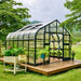 Three-quarter exterior view of the Vego Garden Pacific 12.5ft Wide Greenhouse with Dutch-style doors open.