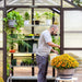 vego pacific 8.5 feet wide greenhouse with gardener in it
