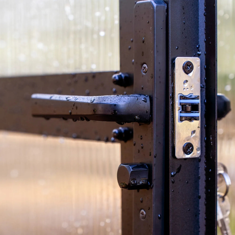 close up view of the door lock and handle of the vego pacific greenhouse