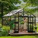 Vego Victorian Greenhouse 10.5ft Wide glass-hybrid model on a landscaped backyard deck with double doors open
