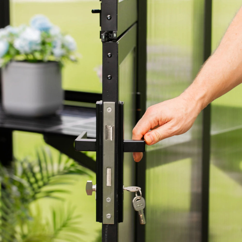 Close-up of the Vego Victorian Greenhouse 10.5ft Wide lockable door handle with a key